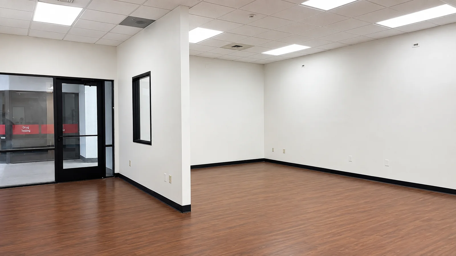 Open work area inside Suite 101B with new flooring and bright ceiling lighting