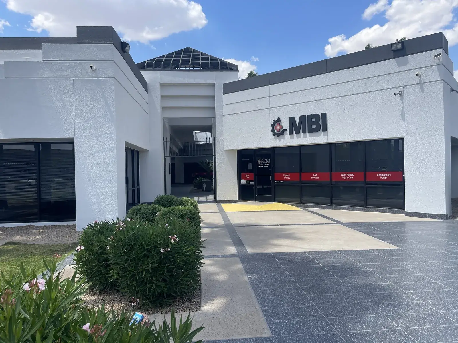 Main entrance walkway with landscaped planters and tenant signage