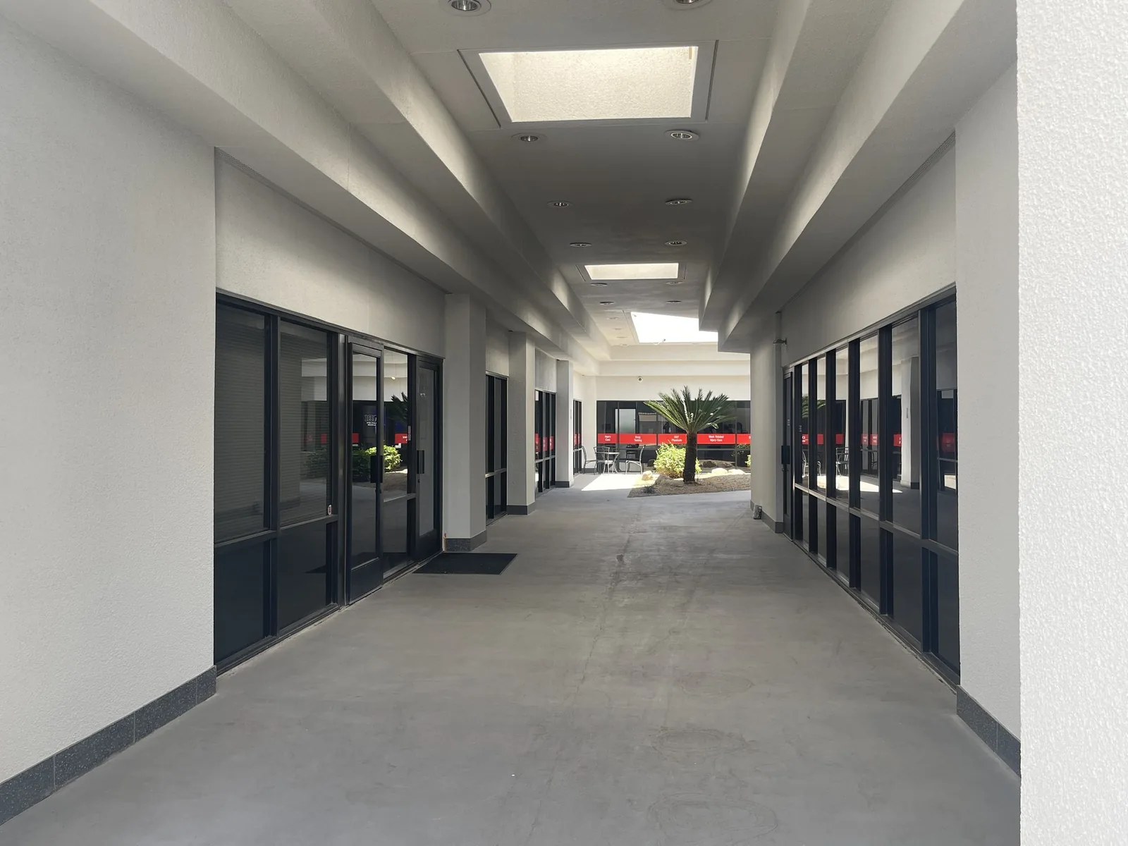 Covered breezeway with skylights leading through the building to the interior courtyard