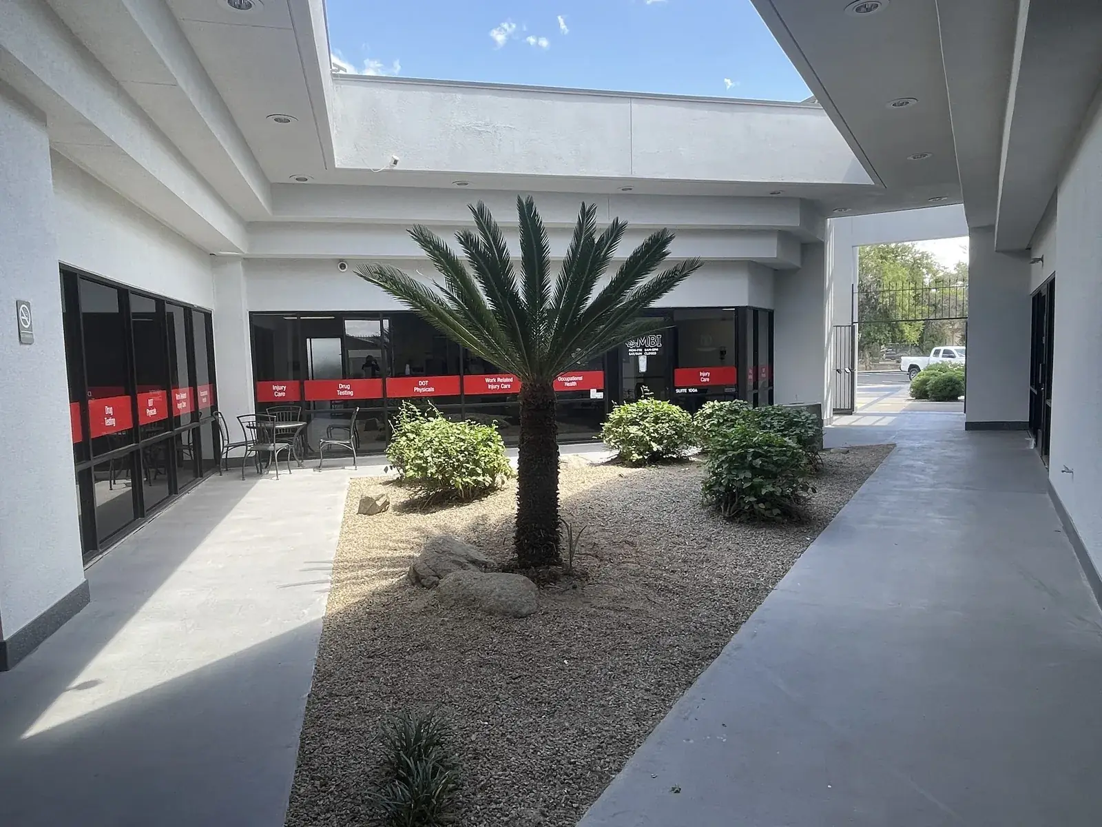 Interior courtyard with sago palm, seating, and suite entrances